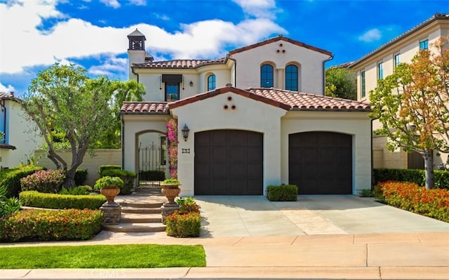 3 Atlantis Cv, Newport Coast, CA 92657 - mediterranean / spanish-style house featuring a tile roof, driveway, stucco siding, and an attached garage