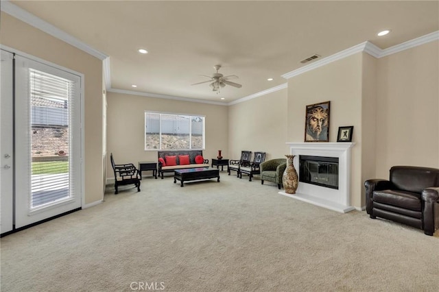 1708 Snowberry Rd, Beaumont, CA 92223 - living room featuring plenty of natural light, carpet flooring, a glass covered fireplace, recessed lighting, and ornamental molding