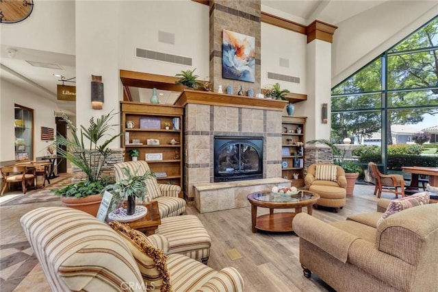 1708 Snowberry Rd, Beaumont, CA 92223 - living room featuring a towering ceiling, a fireplace, and wood finished floors