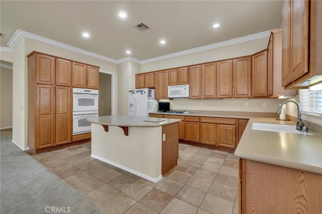 1708 Snowberry Rd, Beaumont, CA 92223 - kitchen featuring white appliances, a center island, crown molding, light countertops, and a kitchen bar