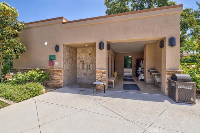 1708 Snowberry Rd, Beaumont, CA 92223 - doorway to property featuring stucco siding, a patio, and stone siding