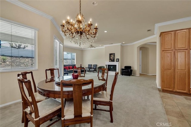 1708 Snowberry Rd, Beaumont, CA 92223 - dining space with arched walkways, crown molding, a chandelier, recessed lighting, and light carpet