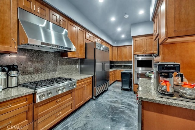 1708 Snowberry Rd, Beaumont, CA 92223 - kitchen with under cabinet range hood, stainless steel appliances, brown cabinetry, tasteful backsplash, and recessed lighting