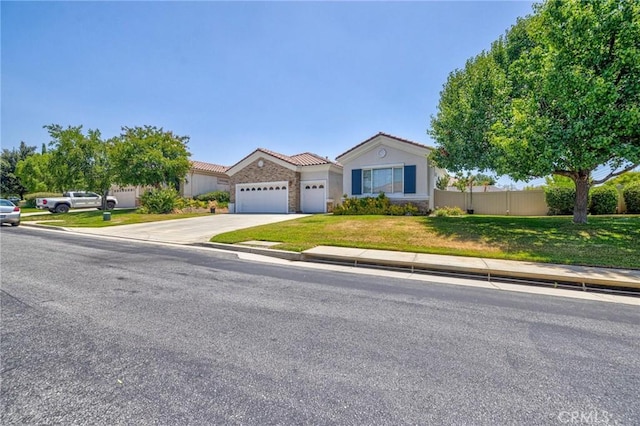 1708 Snowberry Rd, Beaumont, CA 92223 - view of front of house featuring a tiled roof, an attached garage, driveway, stone siding, and stucco siding
