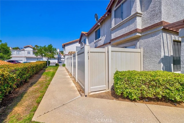 24232 Sylvan Glen Rd Unit A, Diamond Bar, CA 91765 - view of property exterior featuring stucco siding, a tiled roof, and a residential view