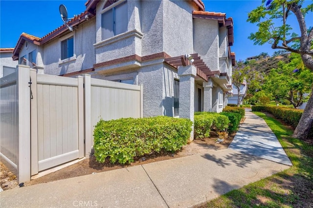 24232 Sylvan Glen Rd Unit A, Diamond Bar, CA 91765 - view of side of home with stucco siding and a tile roof
