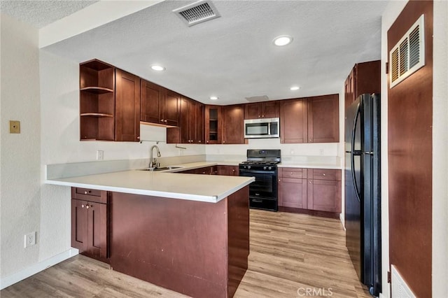 24232 Sylvan Glen Rd Unit A, Diamond Bar, CA 91765 - kitchen with black appliances, light wood-style floors, a peninsula, open shelves, and light countertops