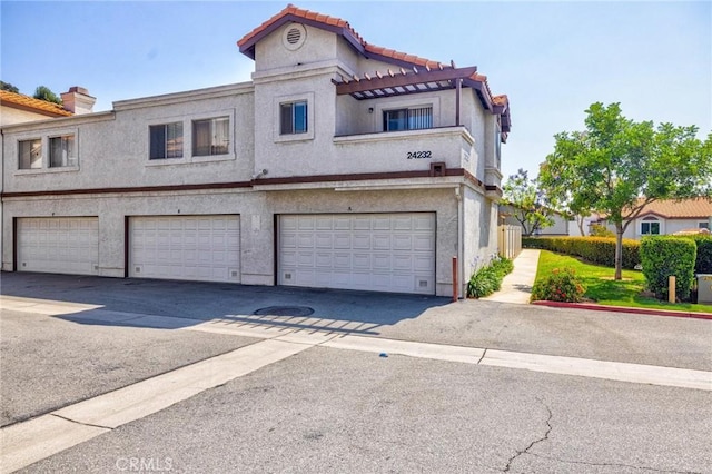 24232 Sylvan Glen Rd Unit A, Diamond Bar, CA 91765 - view of property with stucco siding, a garage, a tiled roof, and driveway