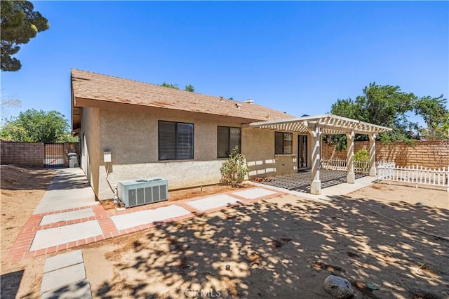37702 Medea Ct, Palmdale, CA 93550 - back of house featuring stucco siding, a pergola, a patio area, a fenced backyard, and a gate