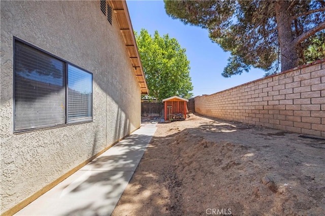 37702 Medea Ct, Palmdale, CA 93550 - view of property exterior featuring stucco siding, a shed, and a fenced backyard