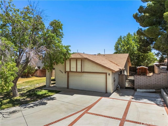 37702 Medea Ct, Palmdale, CA 93550 - view of front of house featuring stucco siding, a gate, concrete driveway, roof with shingles, and a garage