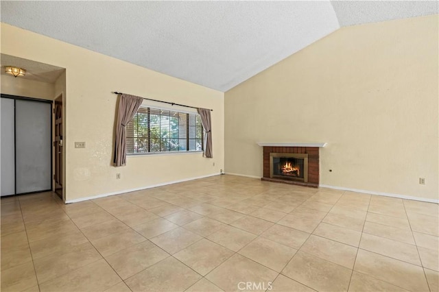 37702 Medea Ct, Palmdale, CA 93550 - unfurnished living room featuring lofted ceiling, light tile patterned floors, a textured ceiling, and a fireplace