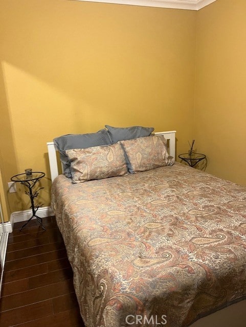 226 E Edinger Ave, Santa Ana, CA 92707 - bedroom with ornamental molding and dark wood-type flooring