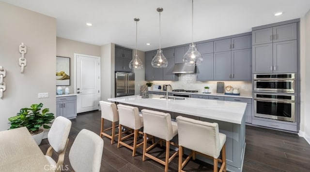 200 Lily Loop, Irvine, CA 92618 - kitchen with appliances with stainless steel finishes, gray cabinetry, decorative backsplash, light countertops, and dark wood-style floors