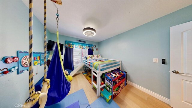 7413 Crimson Dr, Highland, CA 92346 - bedroom featuring wood finished floors and baseboards