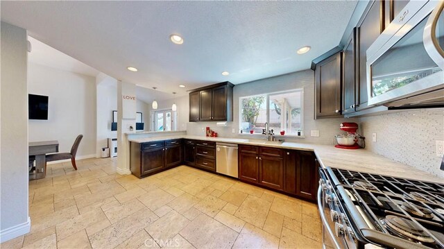 7413 Crimson Dr, Highland, CA 92346 - kitchen with stainless steel appliances, tasteful backsplash, stone tile floors, dark brown cabinets, and recessed lighting