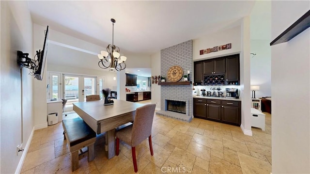 7413 Crimson Dr, Highland, CA 92346 - dining space with stone tile flooring, a brick fireplace, and a chandelier