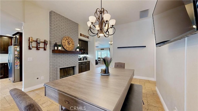 7413 Crimson Dr, Highland, CA 92346 - dining space with stone tile floors, a brick fireplace, and a chandelier