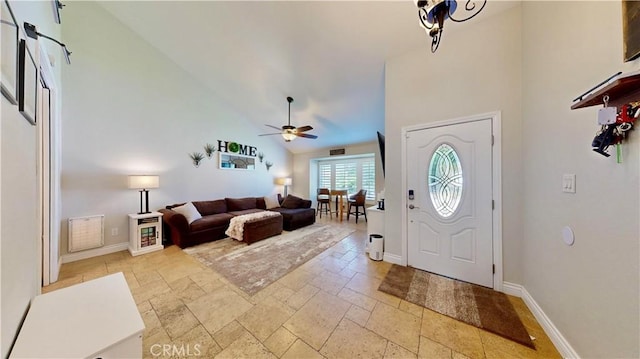 7413 Crimson Dr, Highland, CA 92346 - foyer entrance featuring ceiling fan, high vaulted ceiling, and stone tile flooring