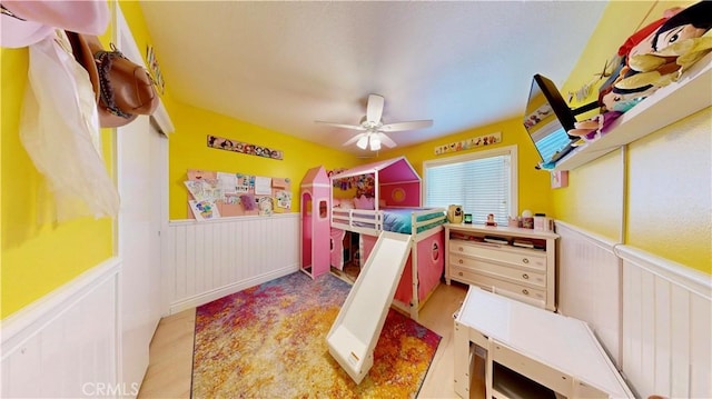 7413 Crimson Dr, Highland, CA 92346 - bedroom featuring wainscoting and a ceiling fan