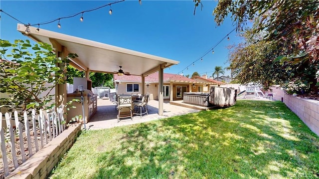 7413 Crimson Dr, Highland, CA 92346 - fenced backyard featuring a hot tub, ceiling fan, and a patio