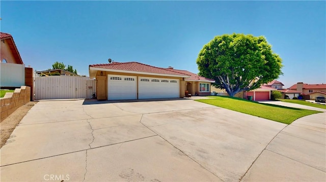 7413 Crimson Dr, Highland, CA 92346 - view of front of house featuring a tiled roof, concrete driveway, a gate, an attached garage, and stucco siding