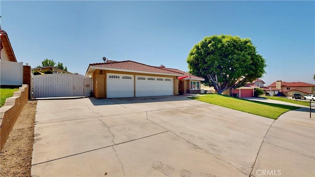 7413 Crimson Dr, Highland, CA 92346 - view of front facade featuring a tiled roof, concrete driveway, a gate, an attached garage, and stucco siding