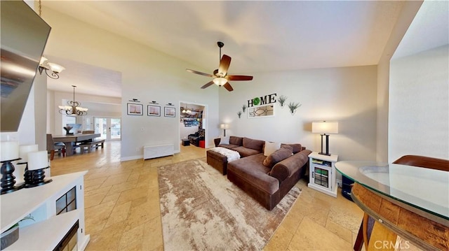 7413 Crimson Dr, Highland, CA 92346 - living area with stone tile floors, a ceiling fan, and a chandelier