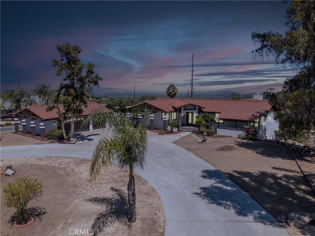16066 Rancho Verde Cir, Riverside, CA 92506 - mediterranean / spanish home with a tile roof, curved driveway, and stucco siding