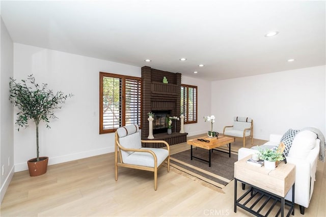 16066 Rancho Verde Cir, Riverside, CA 92506 - living room with light wood-style floors, a fireplace, and recessed lighting
