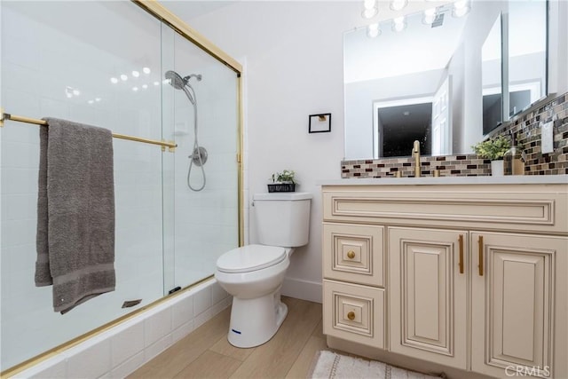 16066 Rancho Verde Cir, Riverside, CA 92506 - bathroom featuring a shower stall, vanity, tasteful backsplash, and wood finished floors