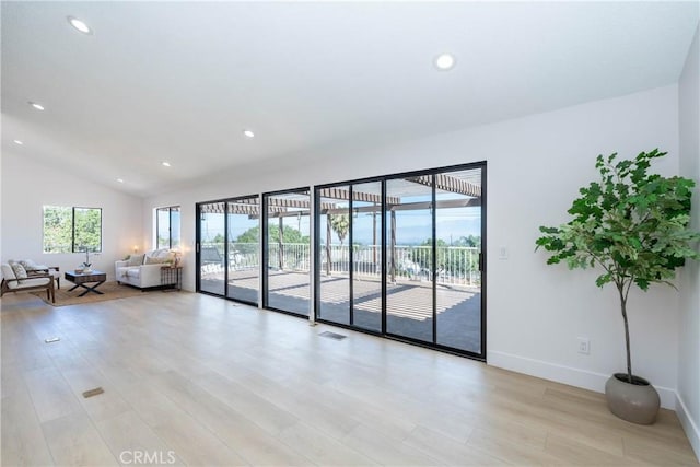 16066 Rancho Verde Cir, Riverside, CA 92506 - spare room with light wood-type flooring, recessed lighting, and lofted ceiling