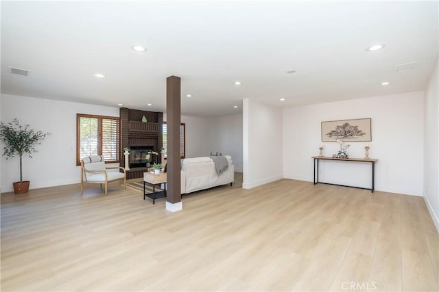 16066 Rancho Verde Cir, Riverside, CA 92506 - living room with light wood-style floors, a fireplace, and recessed lighting