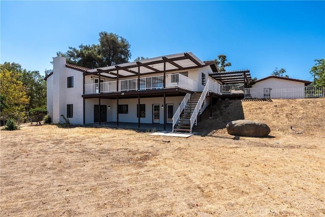 16066 Rancho Verde Cir, Riverside, CA 92506 - rear view of house featuring stairs, stucco siding, a chimney, and a wooden deck
