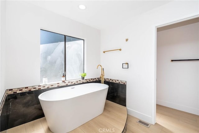 16066 Rancho Verde Cir, Riverside, CA 92506 - full bathroom with a freestanding bath, tile walls, recessed lighting, and wood finished floors