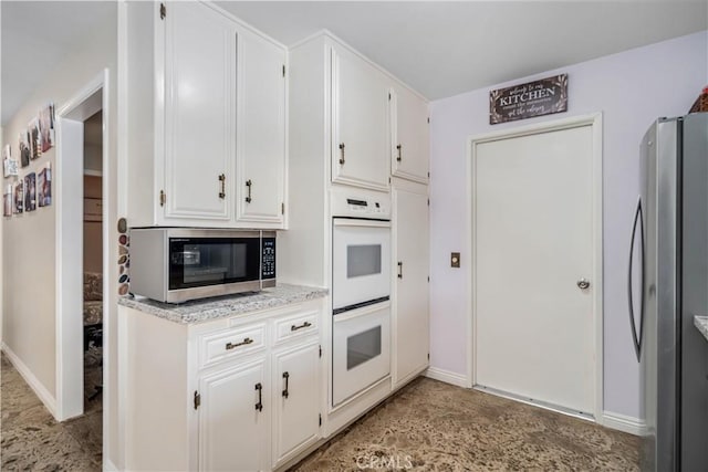 2608 Nice Ct, Lancaster, CA 93536 - kitchen featuring appliances with stainless steel finishes and white cabinets