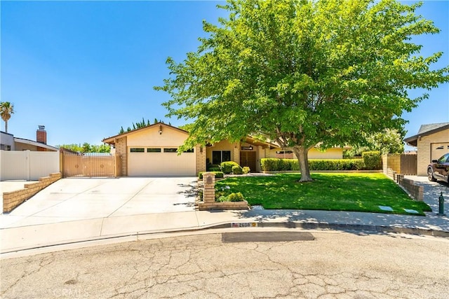 2608 Nice Ct, Lancaster, CA 93536 - view of front facade with an attached garage, concrete driveway, and a gate