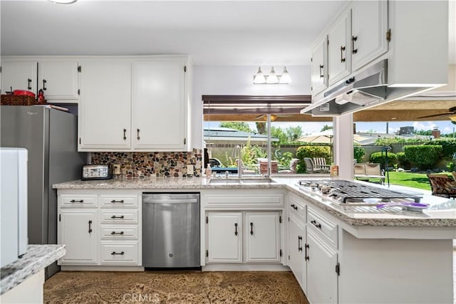 2608 Nice Ct, Lancaster, CA 93536 - kitchen featuring appliances with stainless steel finishes, white cabinetry, decorative backsplash, and under cabinet range hood
