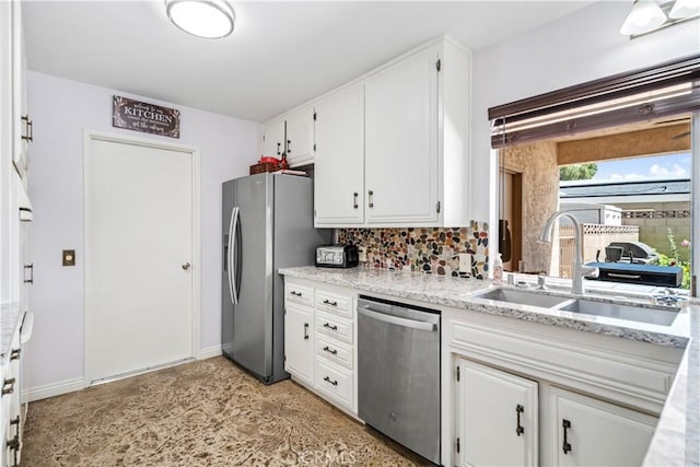 2608 Nice Ct, Lancaster, CA 93536 - kitchen featuring stainless steel appliances, white cabinetry, decorative backsplash, and light stone counters