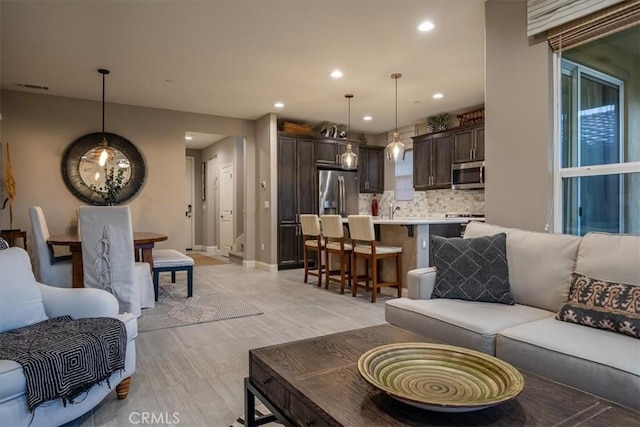 1170 Spring Azure Way Unit 45, Nipomo, CA 93444 - living room with light wood finished floors and recessed lighting
