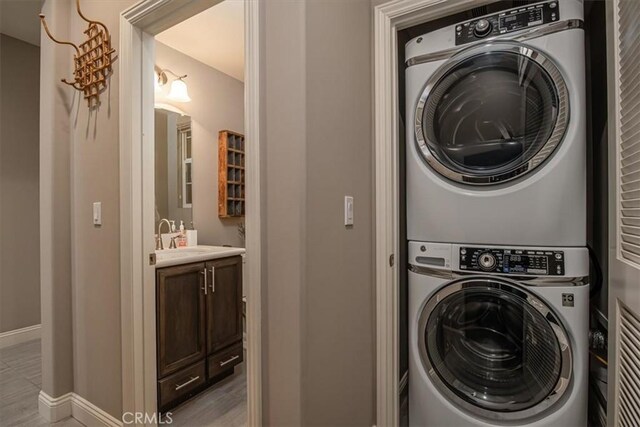 1170 Spring Azure Way Unit 45, Nipomo, CA 93444 - laundry area featuring estacked washer and dryer and light wood-type flooring