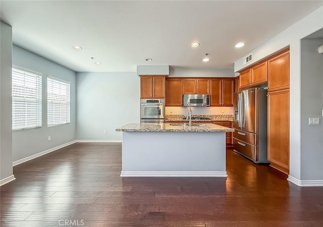 374 E Hilltop Way, Thousand Oaks, CA 91362 - kitchen with stainless steel appliances, light stone countertops, recessed lighting, brown cabinets, and a center island with sink