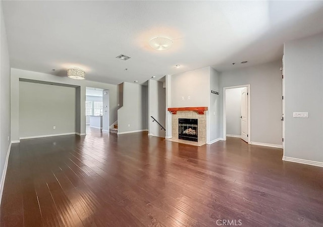 374 E Hilltop Way, Thousand Oaks, CA 91362 - unfurnished living room with wood-type flooring, a tiled fireplace, and stairs