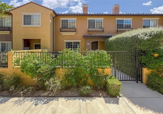 374 E Hilltop Way, Thousand Oaks, CA 91362 - view of front of house featuring a chimney, stucco siding, a gate, and a tile roof