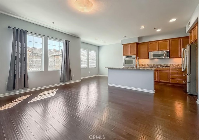 374 E Hilltop Way, Thousand Oaks, CA 91362 - kitchen with stainless steel appliances, brown cabinetry, recessed lighting, a center island with sink, and dark wood-style floors