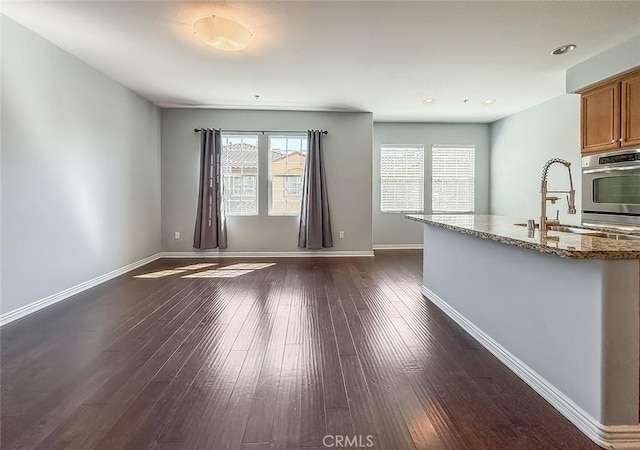 374 E Hilltop Way, Thousand Oaks, CA 91362 - kitchen with oven, stone counters, brown cabinets, dark wood-style floors, and recessed lighting