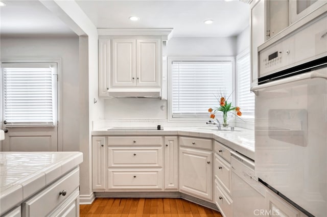 217 E Balboa Blvd, Newport Beach, CA 92661 - kitchen featuring white appliances, tile countertops, white cabinets, light wood finished floors, and recessed lighting