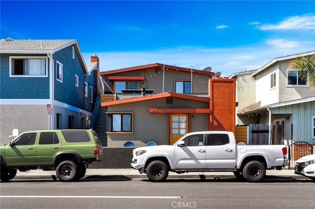 217 E Balboa Blvd, Newport Beach, CA 92661 - view of front of home featuring stucco siding and a chimney