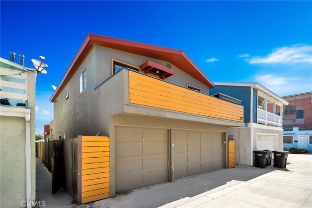 217 E Balboa Blvd, Newport Beach, CA 92661 - view of front of property featuring an attached garage, a balcony, stucco siding, and driveway