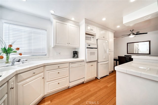 217 E Balboa Blvd, Newport Beach, CA 92661 - kitchen featuring white appliances, tile counters, recessed lighting, light wood finished floors, and white cabinets
